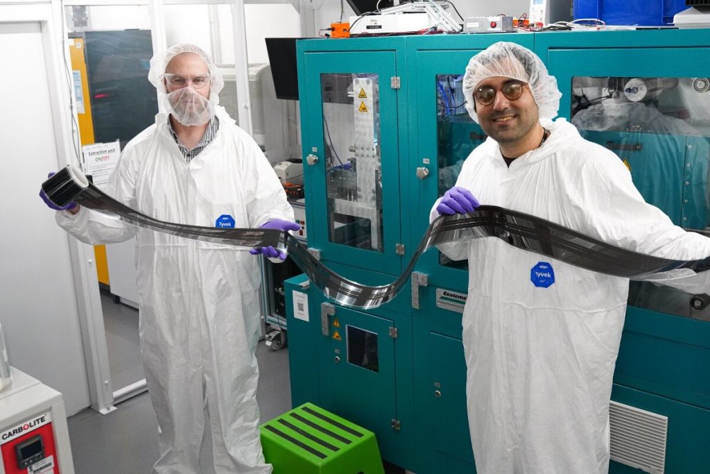Dr Dave Beynon and Dr Ershad Parvazian with a roll-to-roll printed perovskite solar cell.
